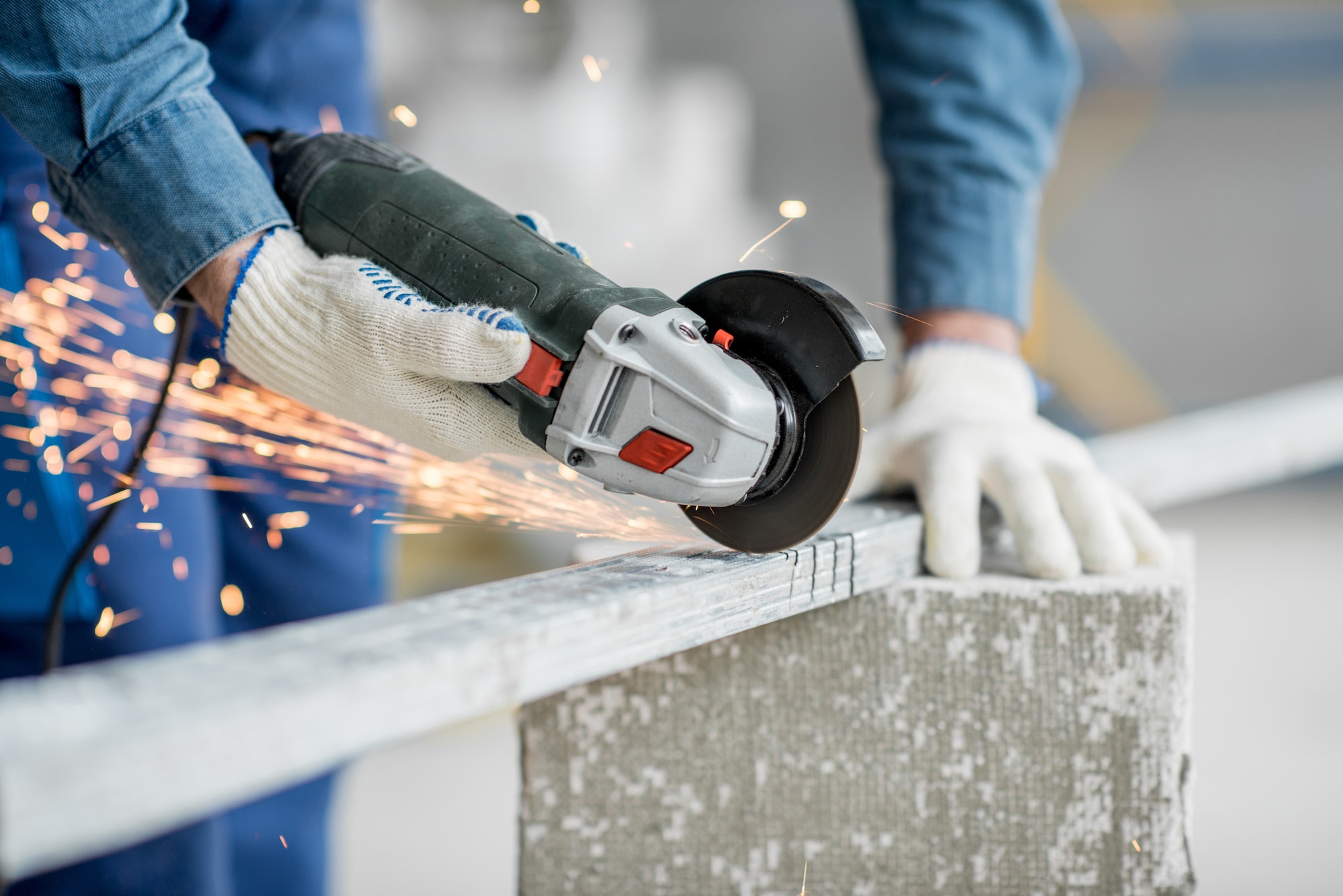 Builder cutting metal indoors