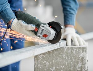 Builder cutting metal indoors